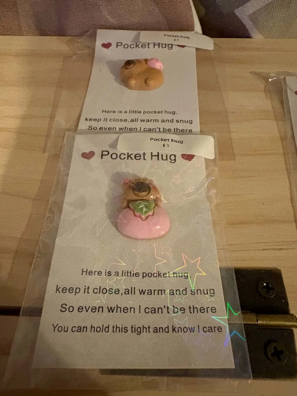 A Pocket Hug card with a tiny capybara charm holding a green leaf